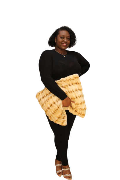 black model holding the tan oversized teddy bear clutch with one hand